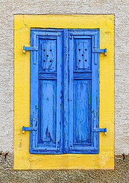 Yellow window reveal with blue window shutter