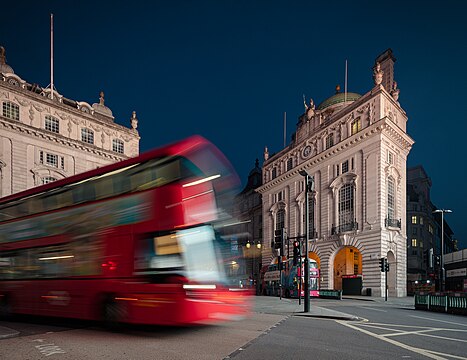 County Fire Office on Piccadilly Circus in the City of Westminster in London, early morning, motion blurred London bus in the foreground