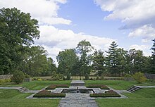 A terraced garden to the east of the house, which has a square fountain in the center