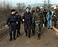 Local policemen and US military personnel on their way to check a post-Dayton resettlement effort