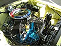 The 390 cid V8 engine in a FR 1968 AMC AMX functionally straddles its front axle, with the centerline of the shock towers basically bisecting the center of the air cleaner