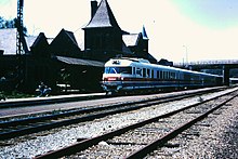 A photograph of a train and several tracks of railroad in front of the Ann Arbor station.