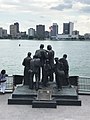 The Gateway to Freedom Monument in Detroit, Michigan, in front of the Detroit River, with a view of Windsor, Canada