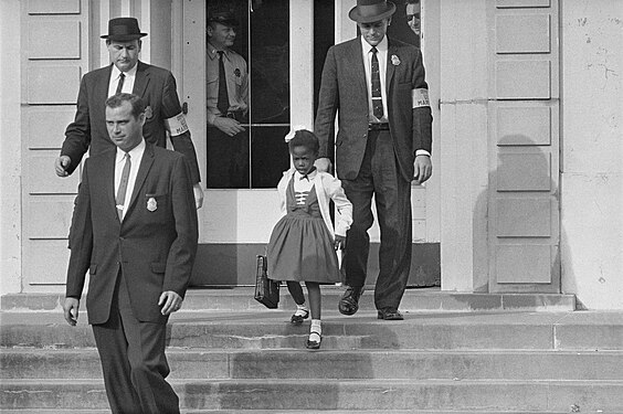 Six year old Ruby Bridges desegregating a school in New Orleans with the protection of US marshals, 1960