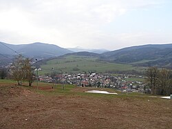 Mladé Buky při pohledu ze sjezdovky. V pozadí Sněžka s hřebeny Krkonoš