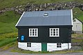 A typical village scene: house with blue postbox of Postverk Føroya. This one was seen in Hellur.