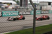 Räikkönen passing Giancarlo Fisichella at the Malaysian GP