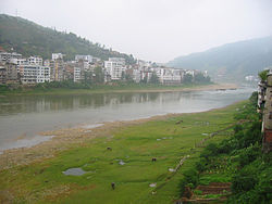 View of the county seat from along the Duliu River (17 August 2003)