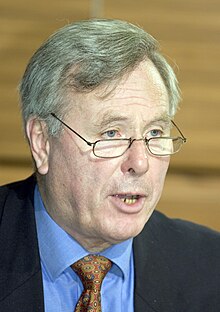 Andreas von Bülow, wearing a black suit, speaking at the 2005 Axis for Peace conference.