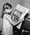 Image 48A girl reading a 21 July 1969 copy of The Washington Post reporting on the Apollo 11 Moon landing (from Newspaper)