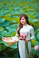 A young girl wearing white áo dài and holding nón lá in her right hand, June 2015