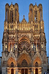 Notre-Dame de Reims façade, gothic stone cathedral against blue sky