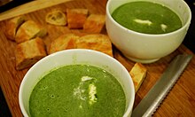 Green garlic and spinach soup, topped with crème fraîche