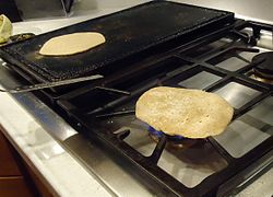 Chapati cooked on open-flame after being cooked on tava.