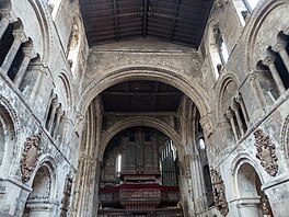 The interior of St. Bartholomew-the-Great, with large rounded stone arches