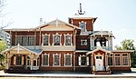 A decorated wooden house in red and white