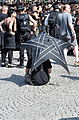 * Nomination Amphi Festival 2013 in Cologne, Germany; Guy with Umbrella sitting behind the concert audience -- Achim Raschka 04:13, 21 August 2013 (UTC) * Promotion Main subject in focus (I want one! ), QI for me. -- Vassil 05:27, 21 August 2013 (UTC)