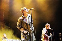 Liam Gallagher (left) and Noel Gallagher of Oasis, with live keyboardist Jay Darlington in background in 2005.