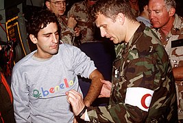 MAJ. Brian Carney, A U.S. Air Force orthopedics surgeon, examines CAPT. Cocciolone, an Italian military officer held prisoner by Iraqi forces during Operation Desert Storm. Cocciolo - DPLA - 43b1d015899576fb8c5c1e96e6f5e984.jpeg