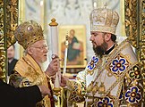 Bartholomew I hands the tomos of autocephaly to Metropolitan Epiphanius.