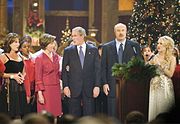 President George W. Bush and Mrs. Laura Bush sing "Hark, the Herald Angels Sing!" along with Dr. Phil McGraw, his wife Robin, left, and Carrie Underwood, right, during the 24th Annual Christmas in Washington at the National Building Museum (11 December 2005)