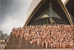 A large group of nude people on the steps of the Sydney Opera House