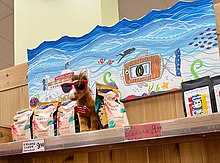 A stuffed animal mascot at a Trader Joe's store