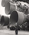 Dr. Wernher von Braun standing by five F-1 engines