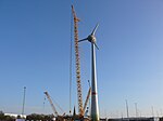 Windkraftanlage 2009 im Aufbau. Dahinter der Kirchturm.