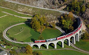 #5–6: Two Rhaetian Railways ABe 4/4 III multiple units with a local train traversing the spiral viaduct near Brusio, Switzerland. – Attribution: Kabelleger / David Gubler (http://www.bahnbilder.ch) (License: GFDL / CC BY-SA 3.0)