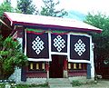 Tsozong Gongba Monastery auxiliary building with 3 'endless knots' above the door.