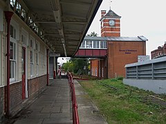 Het stationsgebouw met klokkentoren uit 1912 achter het opgebroken spoor van de Stanmoretak.