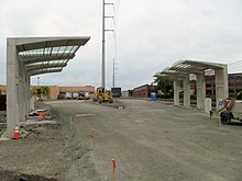 Concrete bus shelters next to a graded loop road