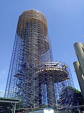 A view of the observation towers from ground level in 2024. The towers are being renovated, and there is scaffolding around each tower.