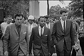 Meredith (center) being escorted to class after the riot