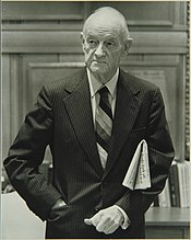 A picture of newspaper publisher John S. Knight, holding a folded up newspaper under his left armpit