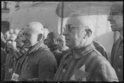 Sachsenhausen detainee with glasses in the foreground wears a two-color ID-emblem