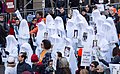 Protesters in New York City wearing veils, holding pictures of victims of gun violence