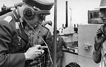 Man in uniform with headphones and throat microphone