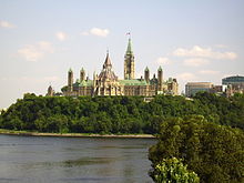 A building with a central clocktower rising from a block