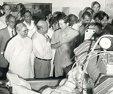 Black and white photograph of Charles in Gujarat with a crowd of people