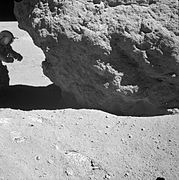 Photographie en noir et blanc de Charles Duke en combinaison spatiale A7L dans l'ombre de Shadow Rock.