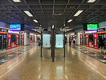 Underground platforms of the NEL, with calligraphic writing on the floor along the length of each platform.