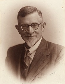 portrait photo with a caption showing the man's name