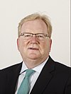 Official Portrait of Jackson Carlaw MSP. He is smiling, with short blonde hair, wearing a suit and tie. There is a white-ish background.