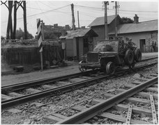 WWII, Europe, France, "Private James E. Boyle, South Wales, Drives Fellow British Soldiers on Train Tracks" - NARA - 195345.tif