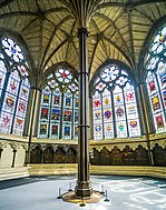 A large, octagonal room with stained-glass windows and a central pillar