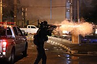 Riot Police fire tear gas to anti-government protesters during Din Daeng Protests on August 2021