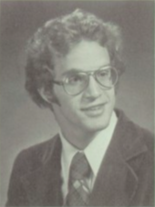 Portrait of teenage man with glasses wearing a suit