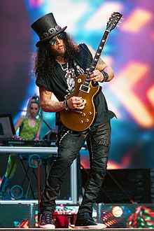 Slash playing guitar onstage